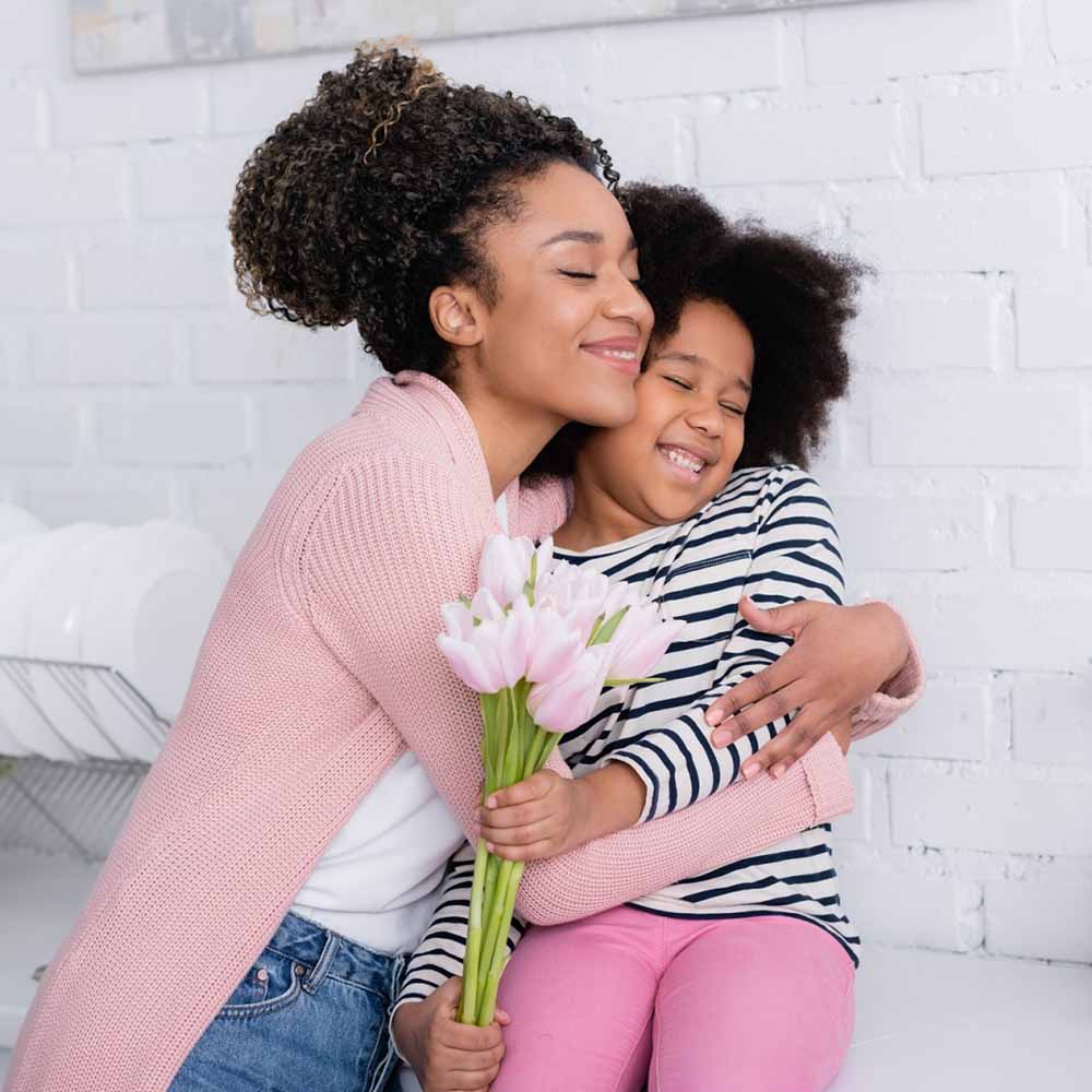 Black Girl with a Bunch of Tulips Embraces Mother eCard